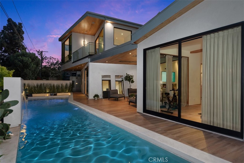 Twilight view of the pool and glass walls at 2398 Redlands Drive